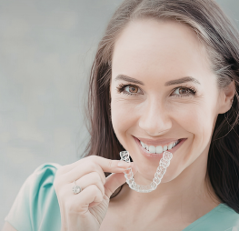 Patient maintaining straight teeth after braces with retainer care